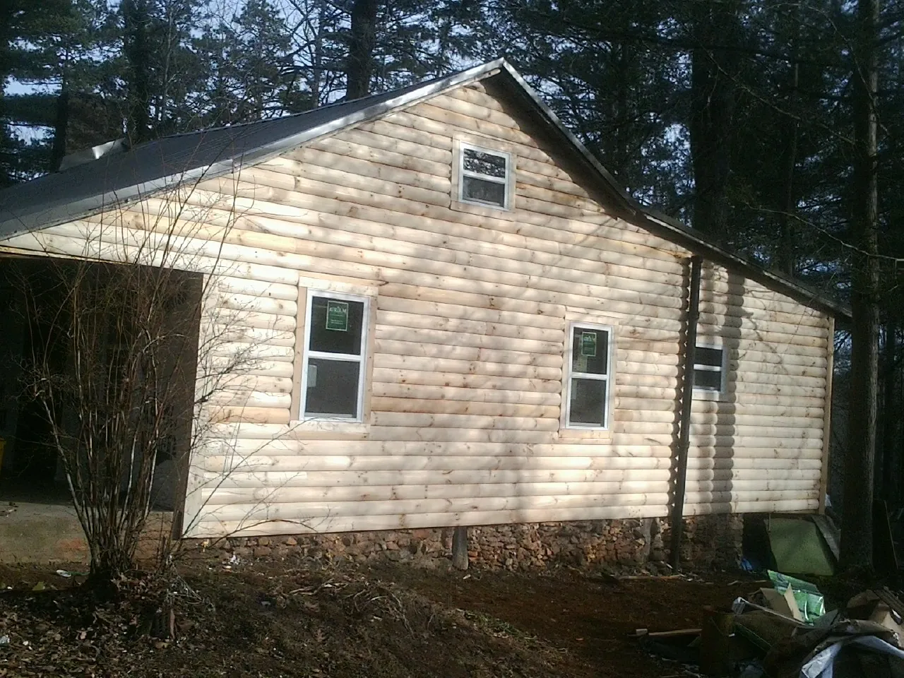 New log siding and dark metal roofing on a gable end in Middleburg